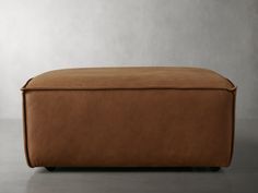 a large brown ottoman sitting on top of a floor