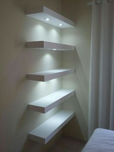 some white shelves are lit up in the corner