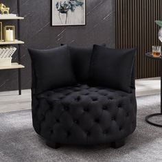 a black round chair sitting on top of a carpeted floor