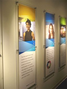 three banners on the wall in an office building