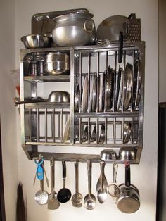 a metal rack with pots and pans on it