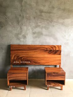 two wooden benches sitting next to each other in front of a cement wall and concrete floor