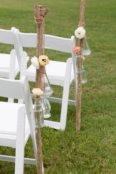 the chairs are decorated with flowers and glass vases for an outdoor ceremony or wedding