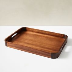 a wooden tray sitting on top of a white table