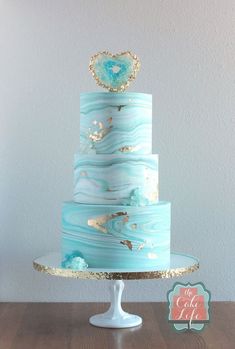 a blue and gold cake on top of a table