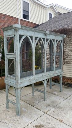 an outdoor area with a large bird cage