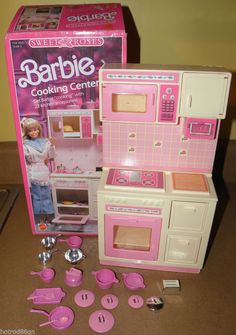 a barbie kitchen and accessories set on a table