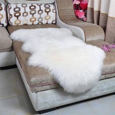 a white fur rug sitting on top of a couch