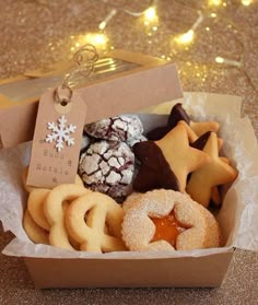 a box filled with lots of different types of cookies and pastries on top of a table