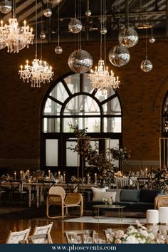 a large room with chandeliers hanging from the ceiling and tables set up for an event