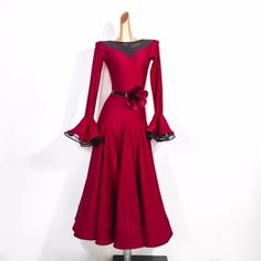 a red dress on display in front of a white wall