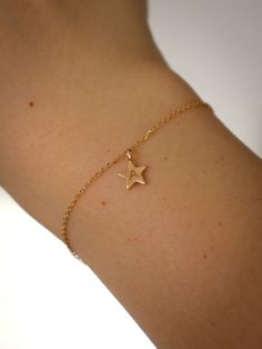 Stellar star bracelet is inspired by the ethereal cosmos and constellations. Our star charm is hand-cut and features a brush finish. Each piece is unique & one-of-a-kind. Made entirely of 10K solid yellow gold. 0.85 mm signature fine delicate gold chain. Star charm measures: 7mm (little over 1/4 inch) excluding bail with 1mm thickness. Brushed finished. Available in 6” (16cm) and 6.5” (17cm) chain. Engraved items cannot be returned or exchanged. H Bracelet, Delicate Gold Chain, Celestial Gifts, Star Bracelet, Initial Bracelet, Solid Gold Jewelry, White Gold Jewelry, Engraved Items, Star Charms