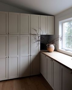 a vase sitting on top of a window sill next to a wooden countertop