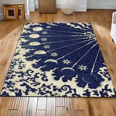 a blue and white area rug with stars, moon and planets on it