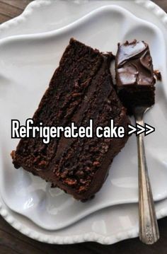 a piece of chocolate cake sitting on top of a white plate next to a fork