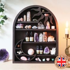 a shelf filled with lots of different types of items next to a vase and candle