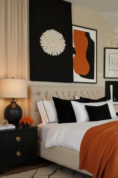 a bedroom with black, white and orange decor