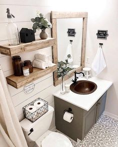 a bathroom with a toilet, sink and shelves above it is decorated in black and white