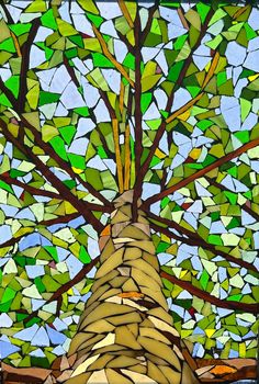 a stained glass tree in front of a blue sky