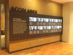 a large sign with pictures on it in front of a wall that says accolables