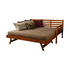 a futon bed with pillows on it and two throw pillows sitting on the back