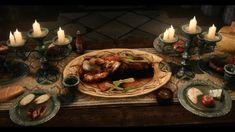 a table topped with lots of food next to candles and plates filled with meats