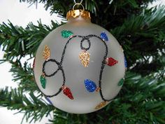 a glass ornament hanging from a christmas tree