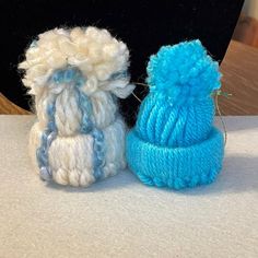 two knitted hats sitting next to each other