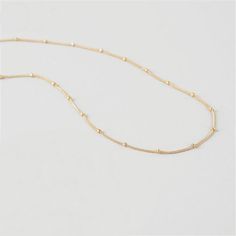 This simple, tiny, short beaded chain necklace is the perfect base to start layering your necklaces. It's very short, but not quite choker length, so it won't get lost within your other pieces. However, this is also a great necklace to wear alone with a higher collar dress or tee! It lays beautifully on top of your collar bone. *Please keep in mind that this necklace will be a little shorter or longer on your depending on the circumference of your neck. DETAILS & SIZE Composition: 18K gold p Minimalist Tiny Beads Chain Necklace For Everyday, Dainty Beaded Chain Layered Necklace, Minimalist Tiny Beaded Necklaces For Layering, Minimalist Beaded Chain Layered Necklace, Minimalist Everyday Beaded Chain Layered Necklace, Minimalist Ball Chain Necklace, Dainty Beaded Chain Necklaces For Layering, Dainty Clavicle Chain Necklace With Round Beads, Dainty Beaded Chain Necklace For Layering