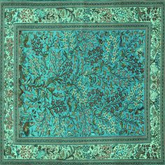 a blue and green area rug with an intricate design on the center, surrounded by leaves