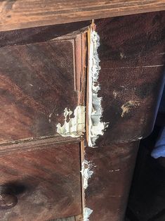 an old wooden dresser with peeling paint on it