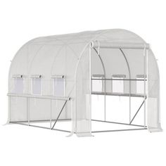 a large white greenhouse with doors open