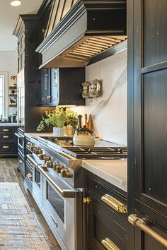 a kitchen with black cabinets and stainless steel stove top ovens in the center, along with an area rug on the floor