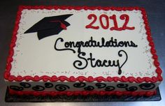 a graduation cake with congratulations written on the top and red trimmings, sitting on a table