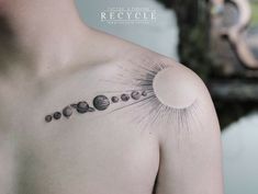 a man's chest with the solar system tattoo on it