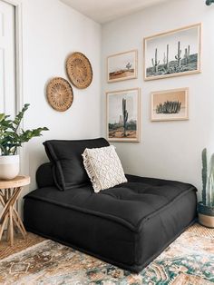 a living room filled with furniture and pictures on the wall