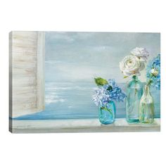 two vases with flowers are sitting on a window sill near the ocean and clouds