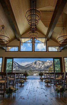 an indoor wedding venue with mountains in the background