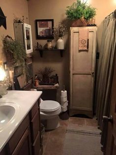 a bathroom with a toilet, sink, and shower stall is shown in this image