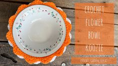 an orange crochet flower bowl cover on top of a wooden table with the words crochet flower bowl koolee