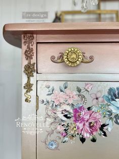 an old dresser has flowers painted on it