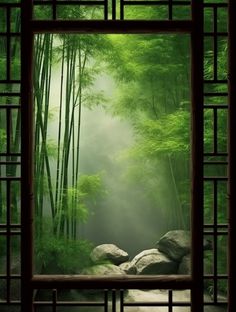 an open window with bamboo trees and rocks in the foreground, surrounded by green foliage