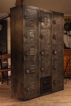 a large metal locker sitting on top of a hard wood floor next to a table