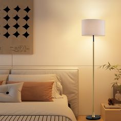 a bed room with a neatly made bed and a large painting on the wall above it