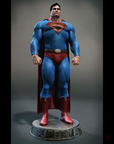 the superman statue is on display in front of a gray background