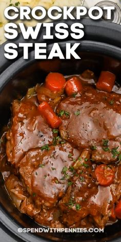 crockpot swiss steak in a slow cooker with carrots and potatoes on the side