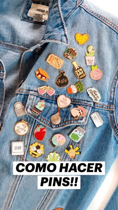 the back of a jean jacket that has various pins on it and is in front of a white background