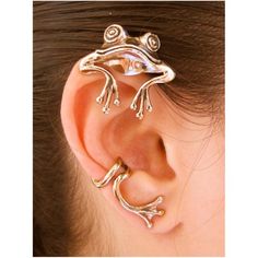 a close up of a person's ear with two pieces of jewelry on it