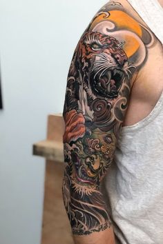 a man with a tiger tattoo on his arm