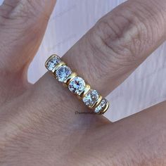 a woman's hand with a diamond ring on it